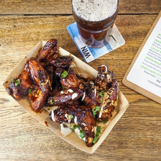Barbecue chicken wings and a pint of frothy Chaucer Ale